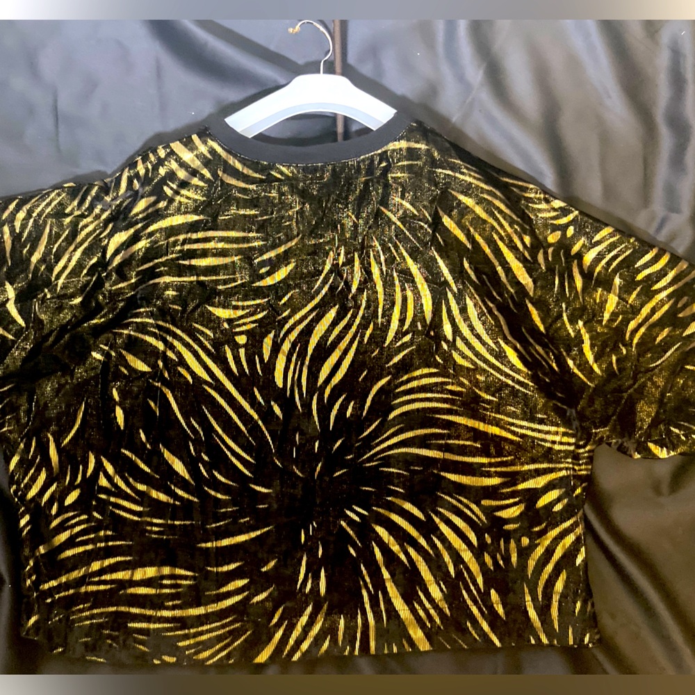 Unique over size fuzzy black and gold top